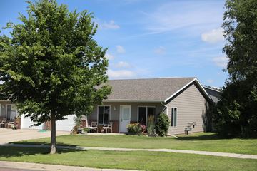 Dell Rapids apartment for rent - A house with a tree in front of it.