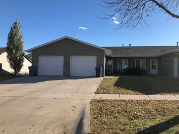 Dell Rapids apartment for rent - A house with a grey roof and a white garage door.