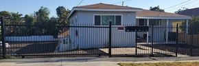 Riverside apartment for rent - a house with a black fence and a gate