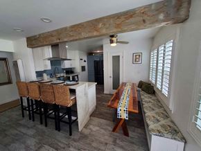Imperial Beach house for rent - a kitchen and dining room with a long wooden table and chairs