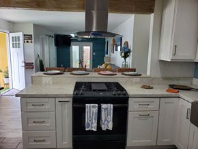 Imperial Beach house for rent - a kitchen with white cabinets and a stove and counter tops