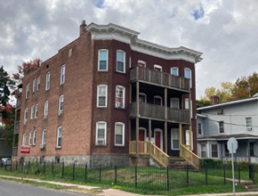 Hartford apartment for rent - a red brick building with two balconies and a fence