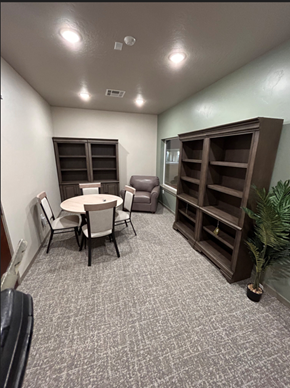 Caldwell apartment for rent - a conference room with a table and chairs and a book shelf