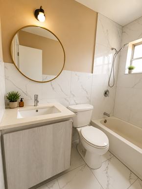 Miami apartment for rent - A bathroom with a sink, toilet and bathtub.