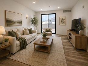 Dodge City apartment for rent - A living room with a white couch, a wooden coffee table, and a flat-screen TV.