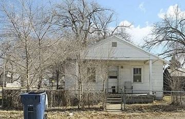 Kansas City house for rent - A white house with a blue trash can in front of it.