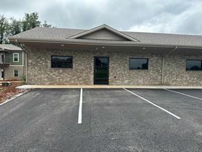 Bowling Green apartment for rent - an empty parking lot in front of a brick building