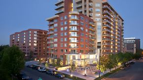 Denver apartment for rent - a rendering of an apartment building on a city street at night