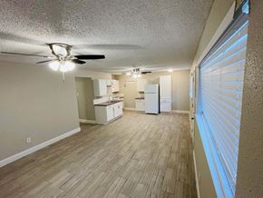 Pasadena apartment for rent - A room with a ceiling fan and wooden flooring.