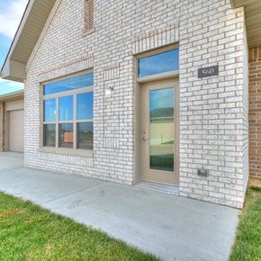 Ames apartment for rent - a brick building with a door and a sidewalk