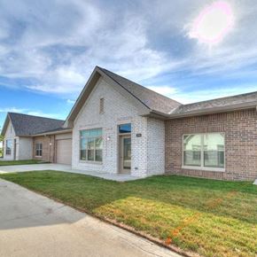 Ames apartment for rent - the front of a brick house with a lawn and a sidewalk