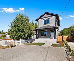 Tacoma apartment for rent - A house with a grey roof and a white picket fence.