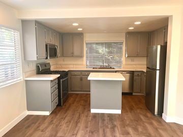 Ventura apartment for rent - A kitchen with wooden floors and white appliances.
