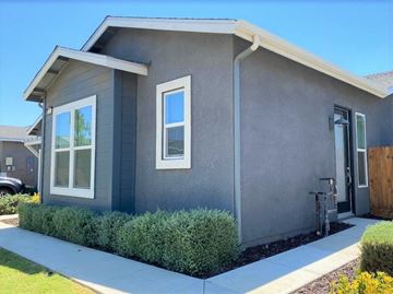Merced house for rent - a gray house with a sidewalk in front of it