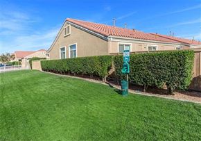 Rosamond apartment for rent - a house with a green sign in the grass