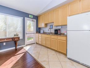 Rosamond apartment for rent - a kitchen with wooden cabinets and a white refrigerator