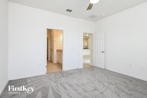 Kissimmee house for rent - a living room with a carpeted floor and a door to a bathroom