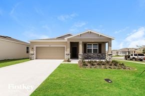 Bartow house for rent - a house with a driveway and lawn in front of it