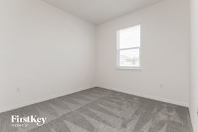 Bartow house for rent - a bedroom with white walls and a window and gray carpet