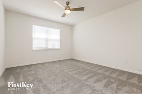 Bartow house for rent - a bedroom with white walls and a ceiling fan