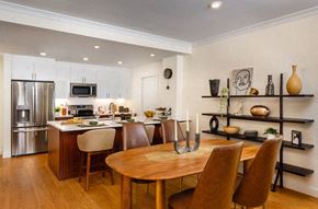 Brookline apartment for rent - A modern kitchen with a wooden table and chairs.