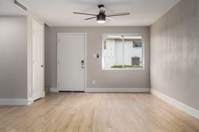 Phoenix house for rent - an empty room with a window and a ceiling fan