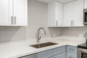 Phoenix house for rent - a white kitchen with a sink and white cabinets