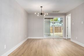 Phoenix house for rent - an empty living room with a chandelier and a door to a yard