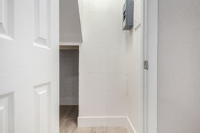 Phoenix house for rent - a room with white walls and a white door and a bathroom