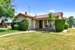 Fresno apartment for rent - a house with a lawn and a palm tree