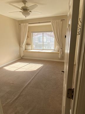 Phoenix apartment for rent - an empty living room with a window and a ceiling fan