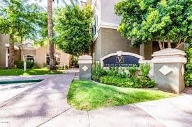 Phoenix apartment for rent - an apartment building with a driveway and a sign in front of it