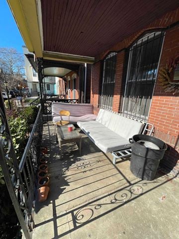 Philadelphia house for rent - a patio with a couch and a table on a balcony