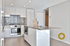 Richmond house for rent - a white kitchen with a counter top and a stove