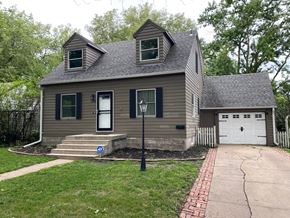 Fremont house for rent - a brown house with a white garage and a street light