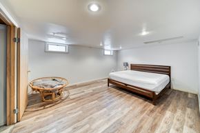 Fremont house for rent - a bedroom with a bed and a chair and a door