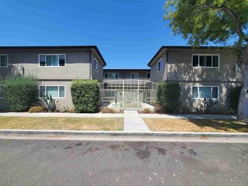 Long Beach apartment for rent - front view of an apartment building with a gate and sidewalk
