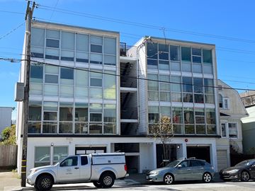 San Francisco apartment for rent - an apartment building with cars parked in front of it