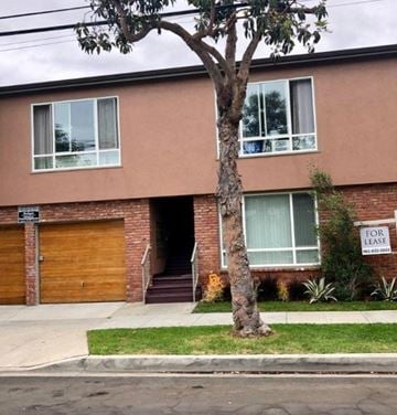 Long Beach apartment for rent - a brick house with a tree in front of it
