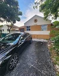 Cutler Bay house for rent - A black car is parked on a driveway in front of a house.