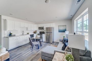 Lima apartment for rent - the living room and kitchen of a home with a couch and a table