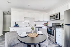 Lima apartment for rent - a kitchen with stainless steel appliances and a table and chairs