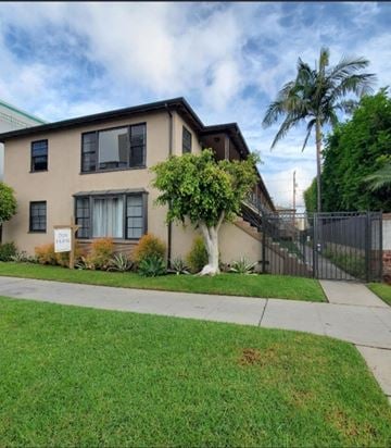 Long Beach apartment for rent - a house with a sidewalk and a palm tree in front of it