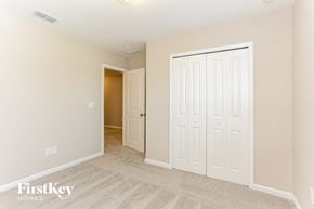 Yulee house for rent - a bedroom with two closets and a door to a hallway