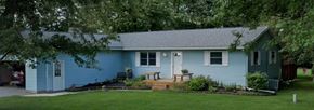 Elida house for rent - A blue house with a white door and windows.