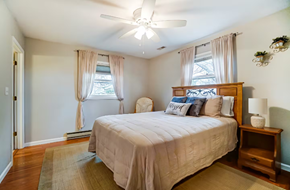 Elida house for rent - A bedroom with a large bed and a ceiling fan.