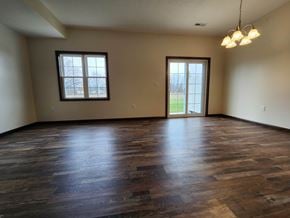 Elida apartment for rent - A room with wooden floors and a chandelier.