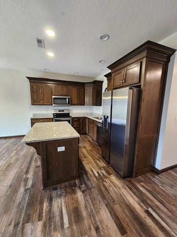 Elida apartment for rent - a kitchen with wooden cabinets and a stainless steel refrigerator