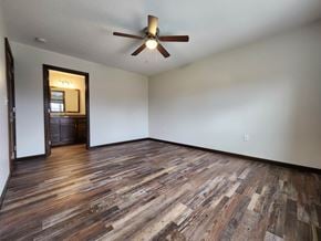 Elida apartment for rent - A room with a ceiling fan and wooden flooring.