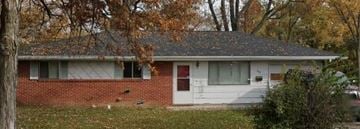 Lima house for rent - a red brick house with a white door     and trees